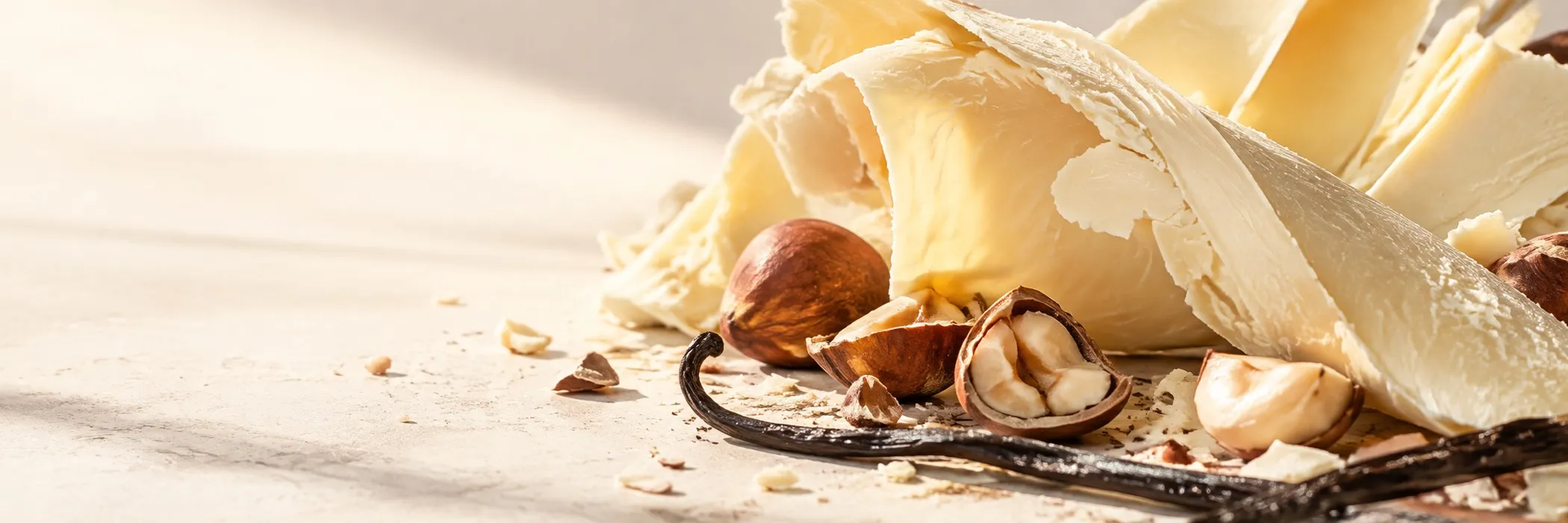 Studio close-up of hazelnuts tumbling through white chocolate